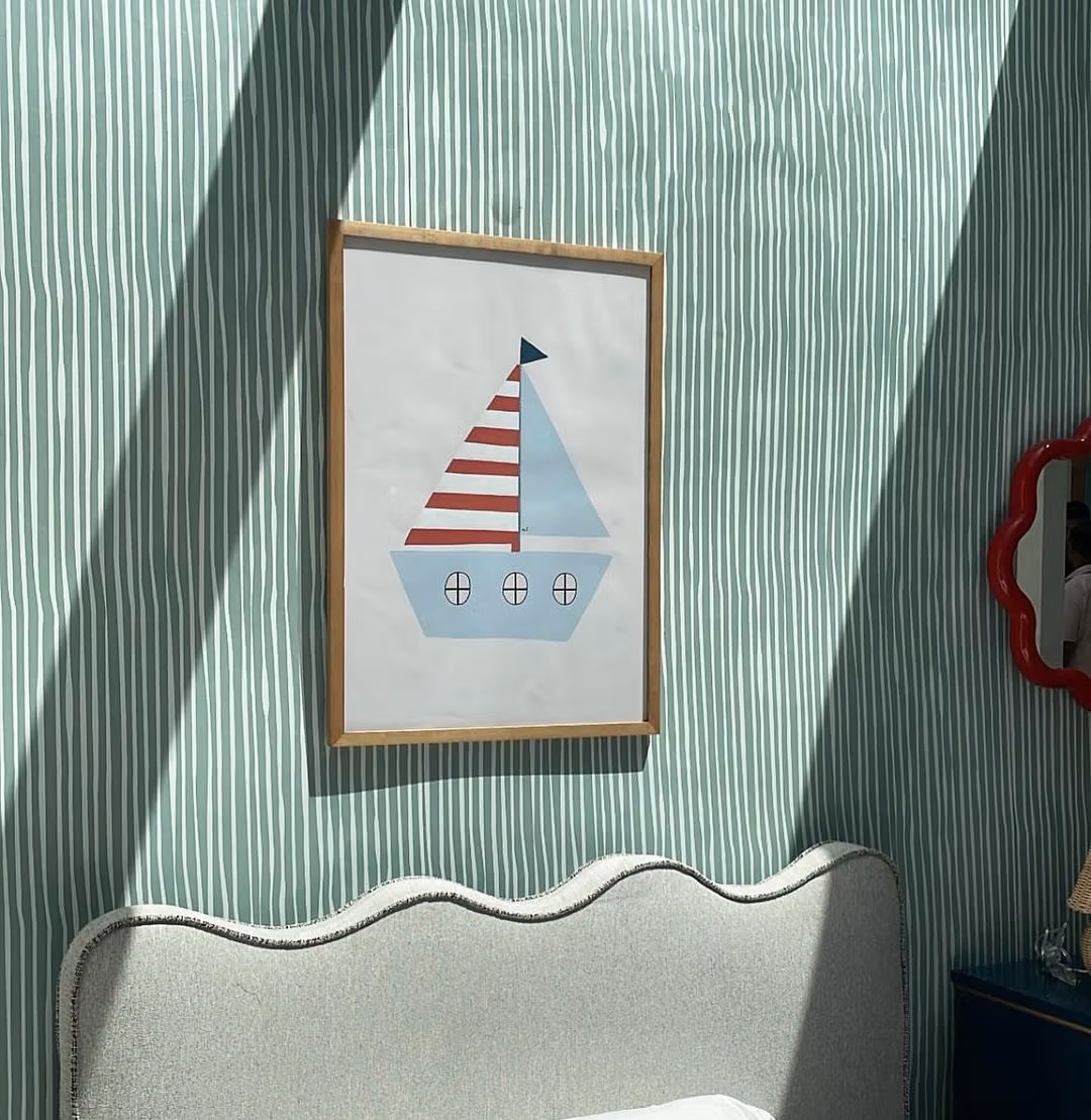 A layered interior with ShopSeif striped wallpaper and objects collected over time